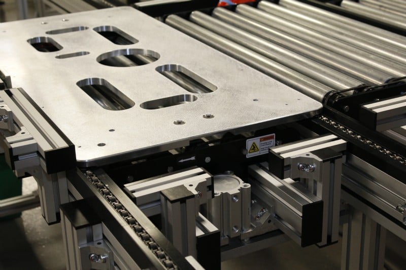 Machined pallet on a pallet handling conveyor system
